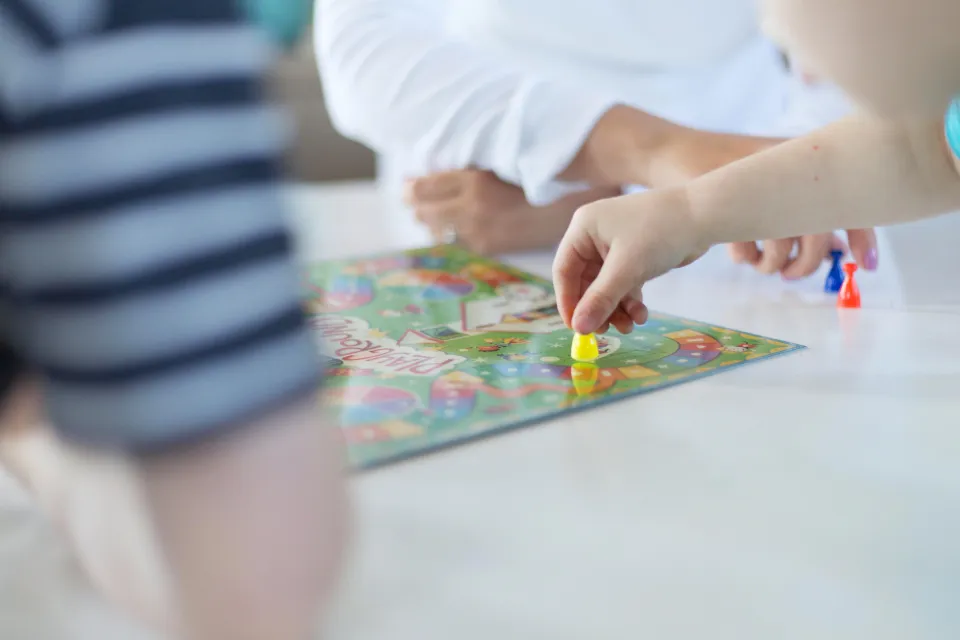 Hands playing a board game together