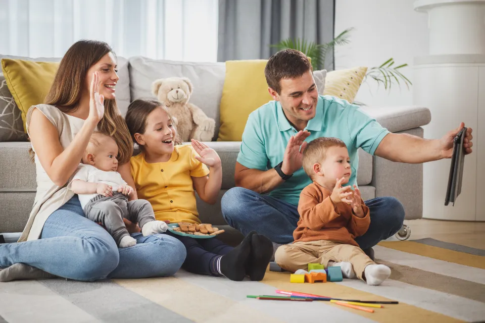 A family playing together on the living room floor