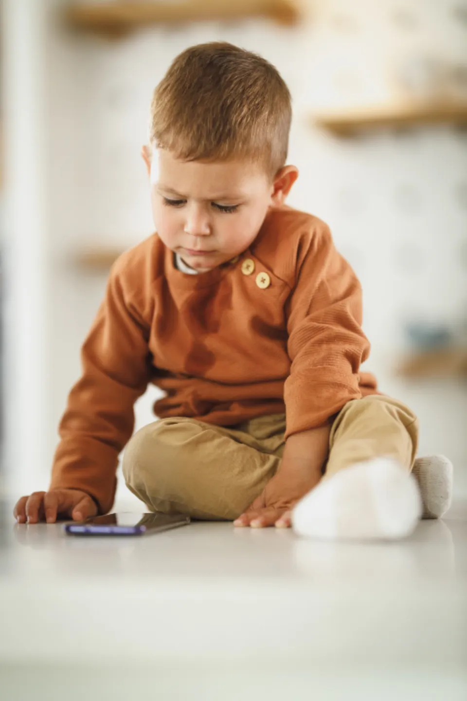 A young child playing on the floor at home